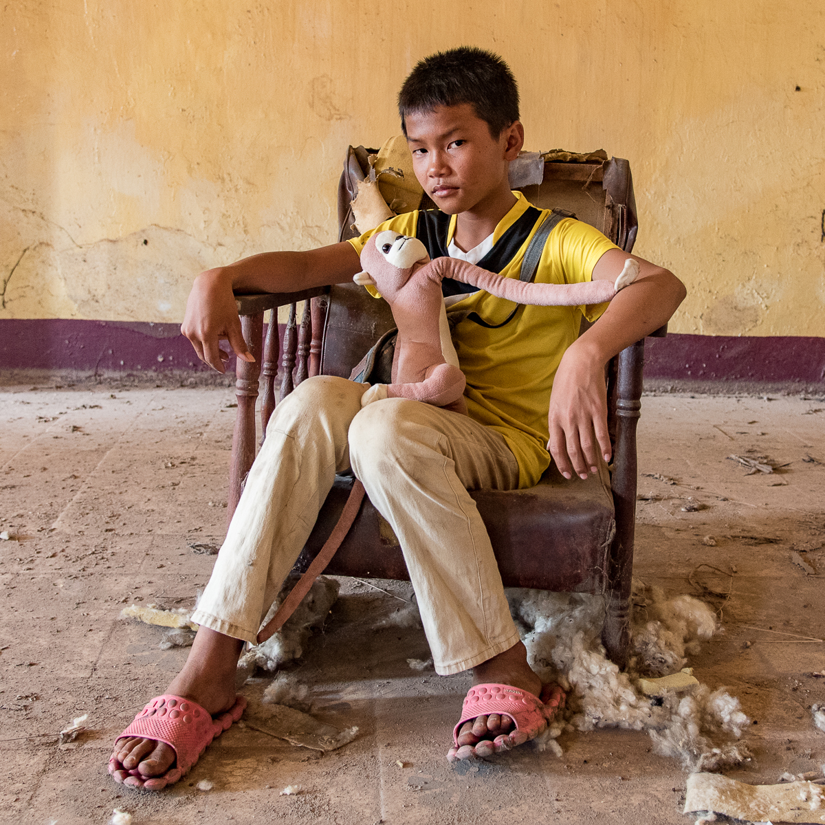 Boy in abandoned hotel Vientiane