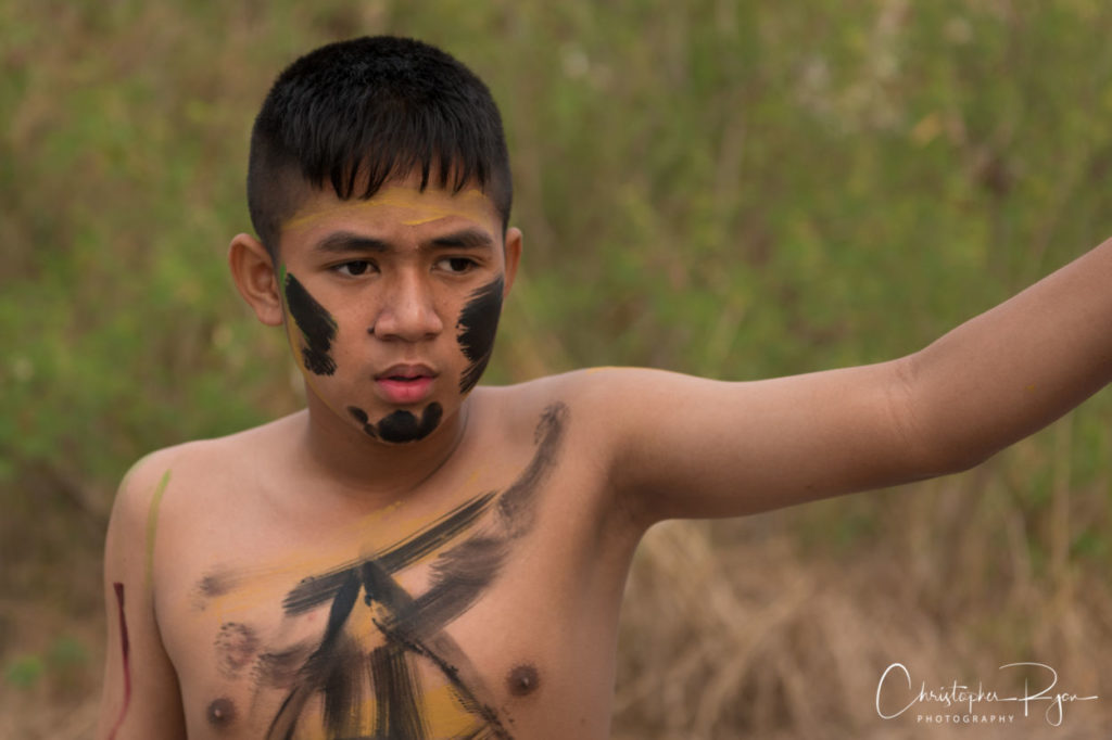 shirtless boy with tribal bodypaint