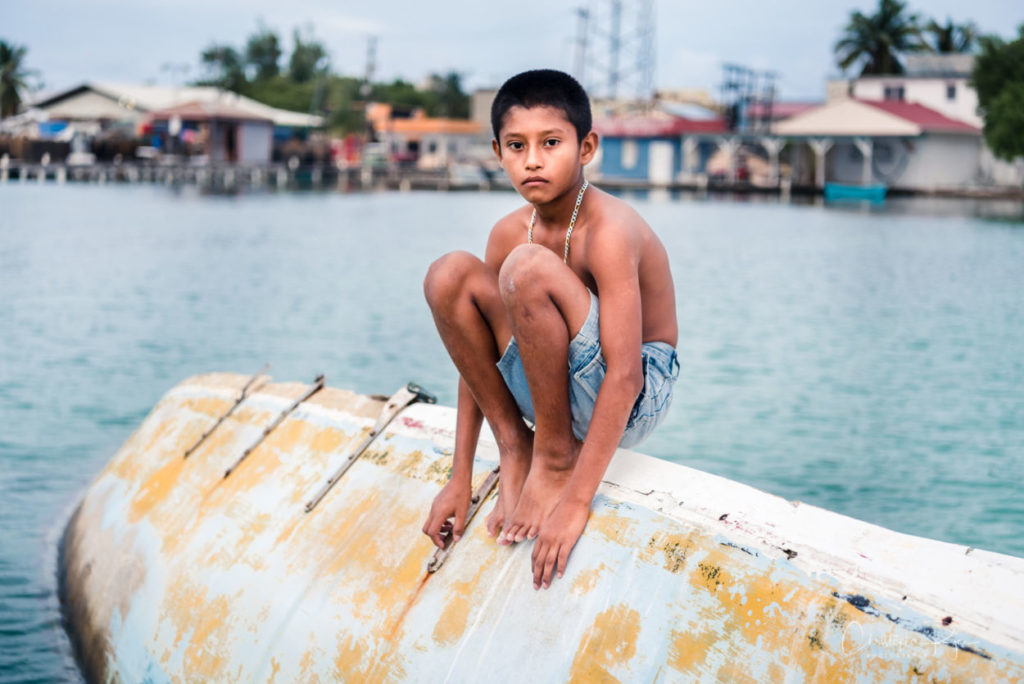 boy posing on abandoned boats for the youth and urban decay photography project