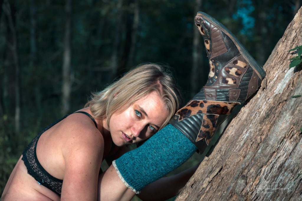 Blond girl stretching and showing off sexy cowgirl boots