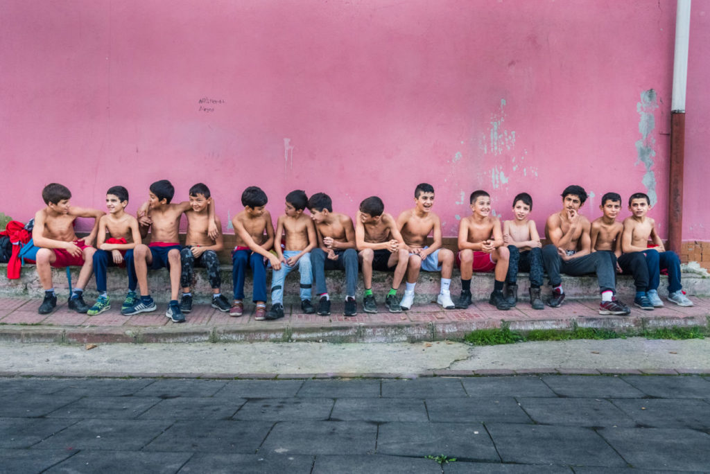a group of boys outside of a turkish oil wrestling gym