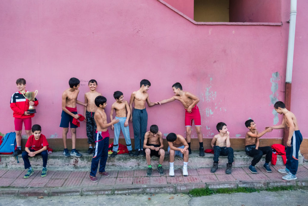 child and teen boys shirtless outside a gym in Istanbul, Turkey