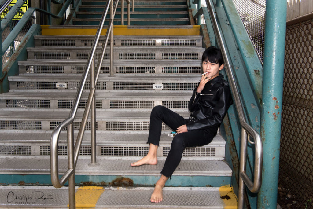 barefoot and sexy teen boy sitting on stairs at NYC subway entrance