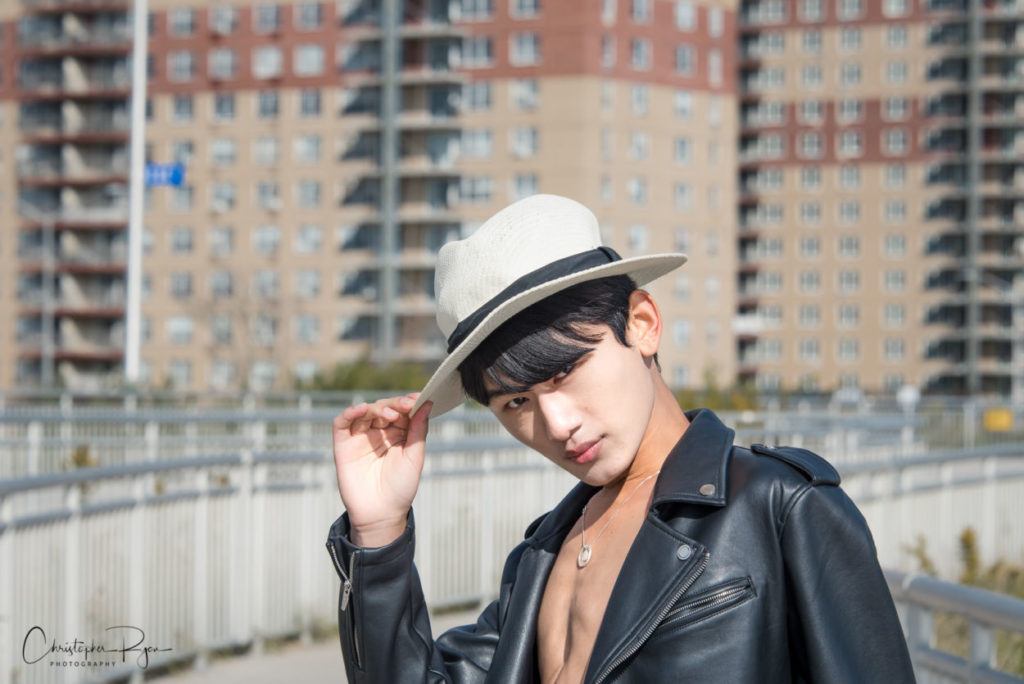 asian teen fashion boy wearing open leather jacket and white hat