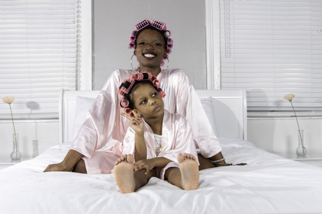 barefoot african american girl with mom