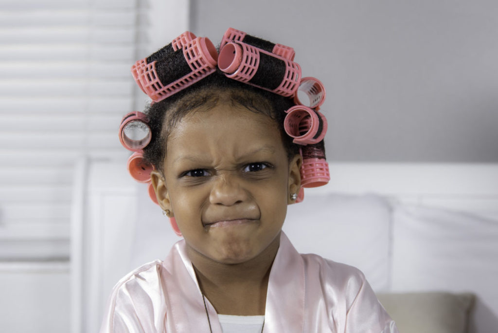 baby girl in pink curlers